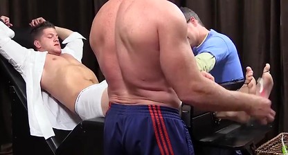 Restrained businessman tickle tormented by dominant guys