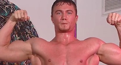 Wet Bodybuilder Poses with a Hard On on a Stripper Pole